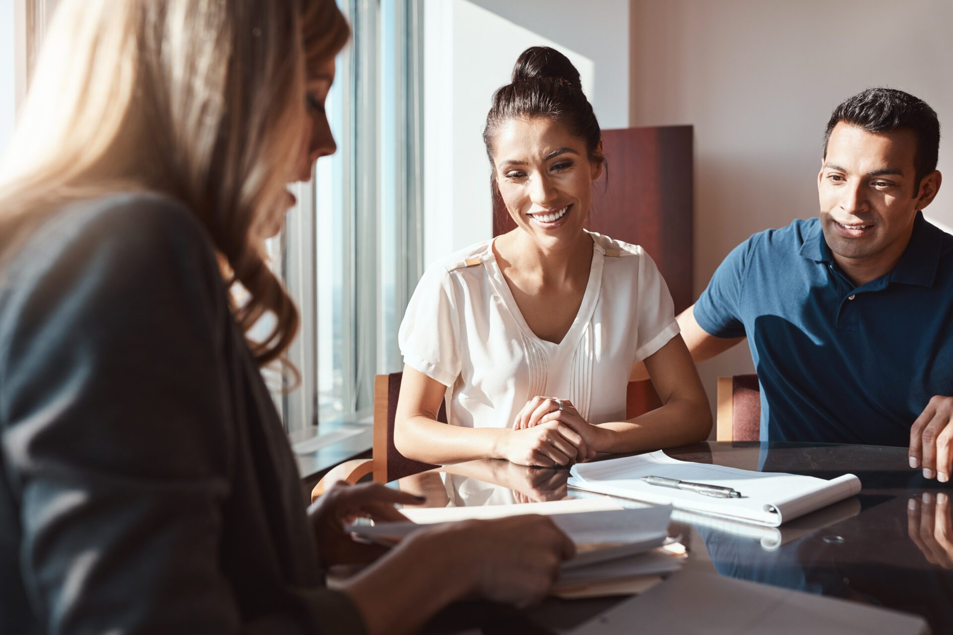 Making sound financial decisions for the sake of their future. a young couple meeting with a financial planner in a modern office. Making sound financial decisions for the sake of their future. a young couple meeting with a financial planner in a modern office